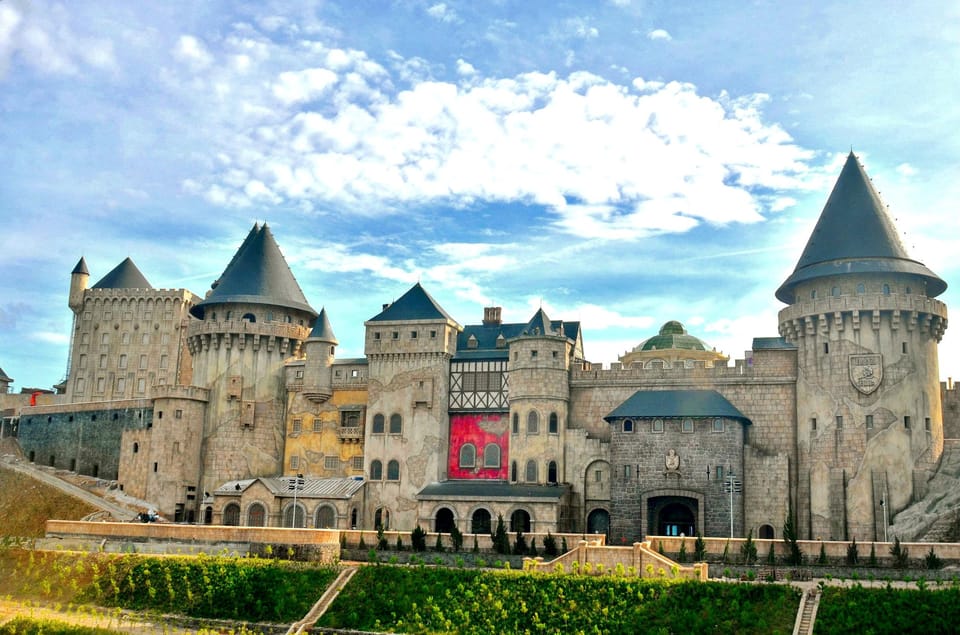 From Da Nang: Ba Na Hills Golden Bridge Private Tour & Lunch - French Village at 11:00 AM: miniature Europe, stone church, and festival energy